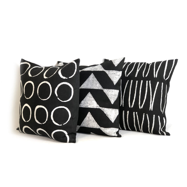 Three Sadza Triangles pillow covers with black and silver geometric patterns