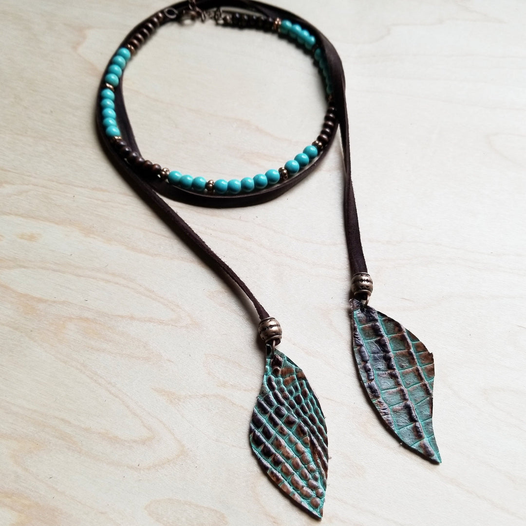 Turquoise blue bead collar necklace with black cord and leaf pendant drop details.