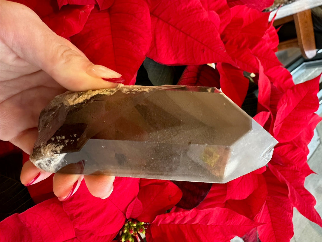 Smoky quartz crystal with phantom-like bands and polished pointed tip