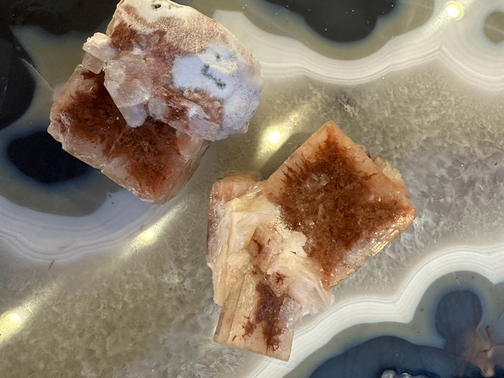 Red-brown apophyllite cube with white crystal formations and small clear sections
