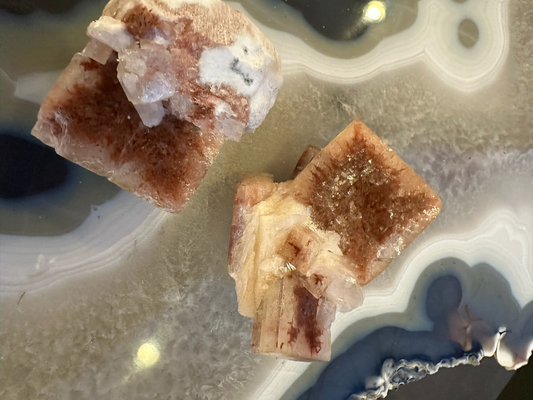 Apophyllite cube with red-brown and white mineral crystals, clear edges visible