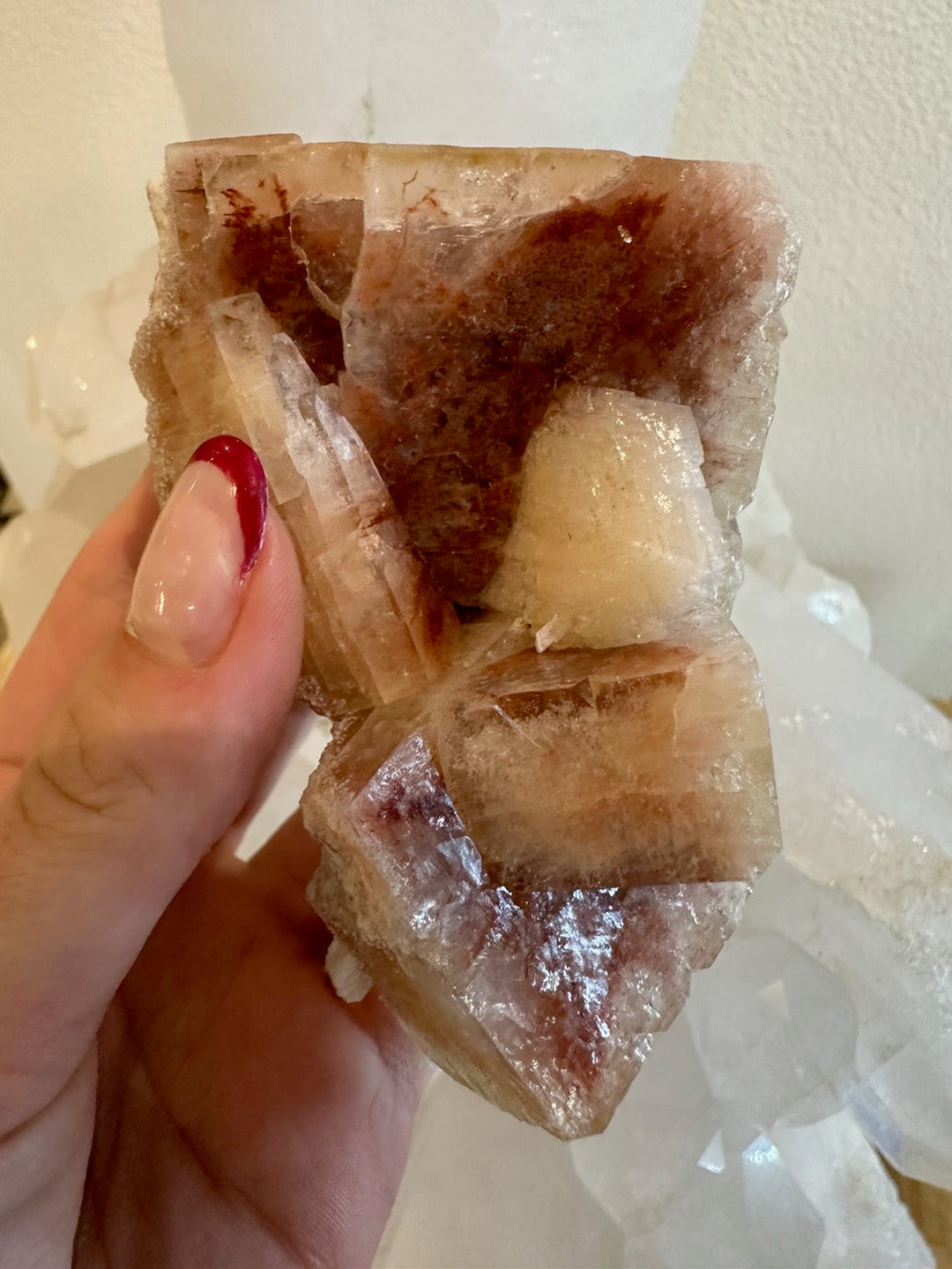 Red apophyllite cube cluster with multiple clear cube faces and white inclusions