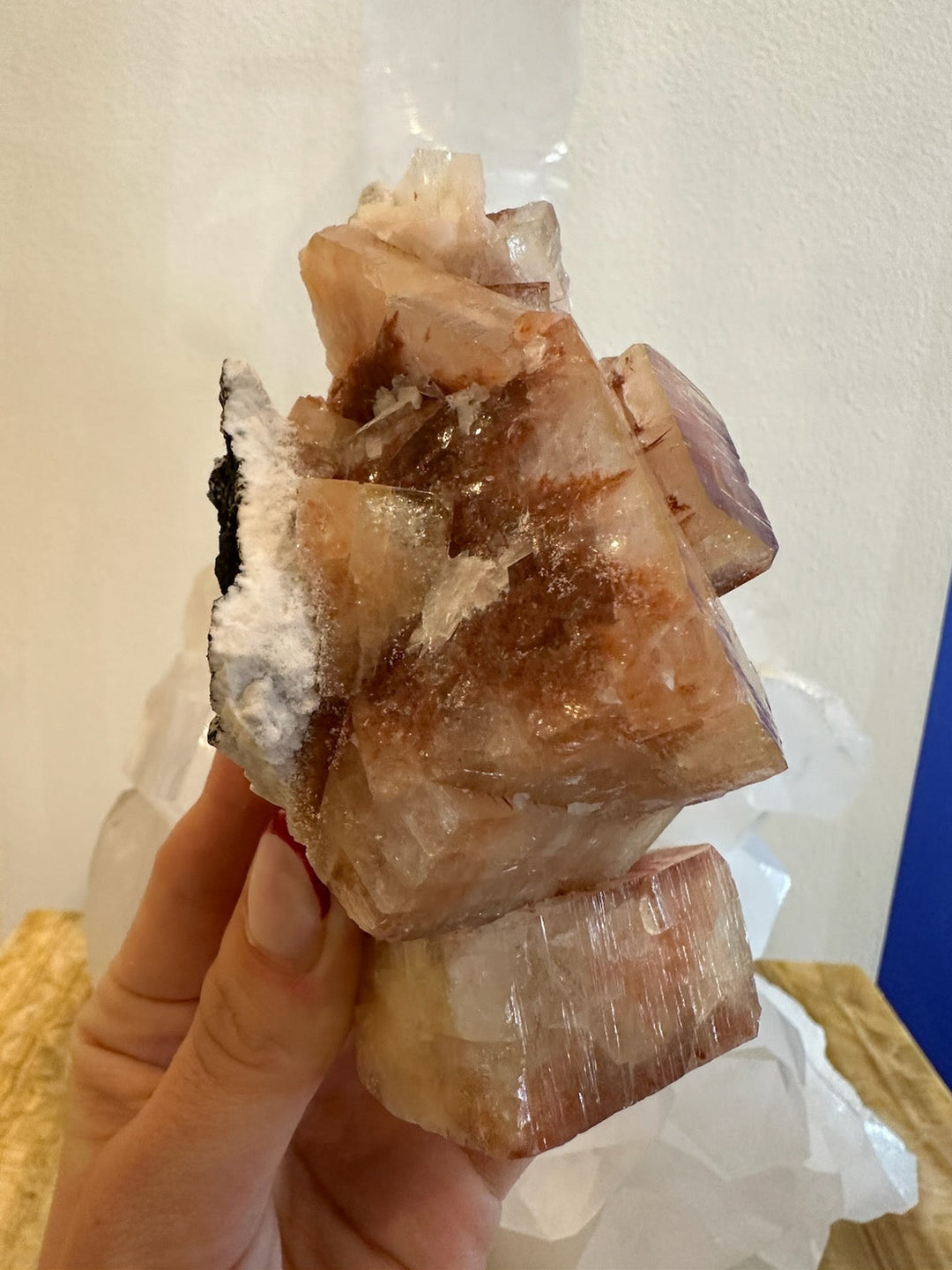 Warm brown apophyllite crystal with cube facets and white matrix, handheld
