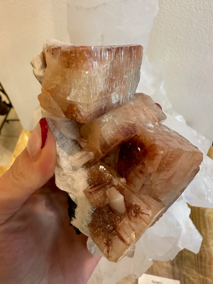 Brownish-red apophyllite cubes with stilbite points on white rock matrix