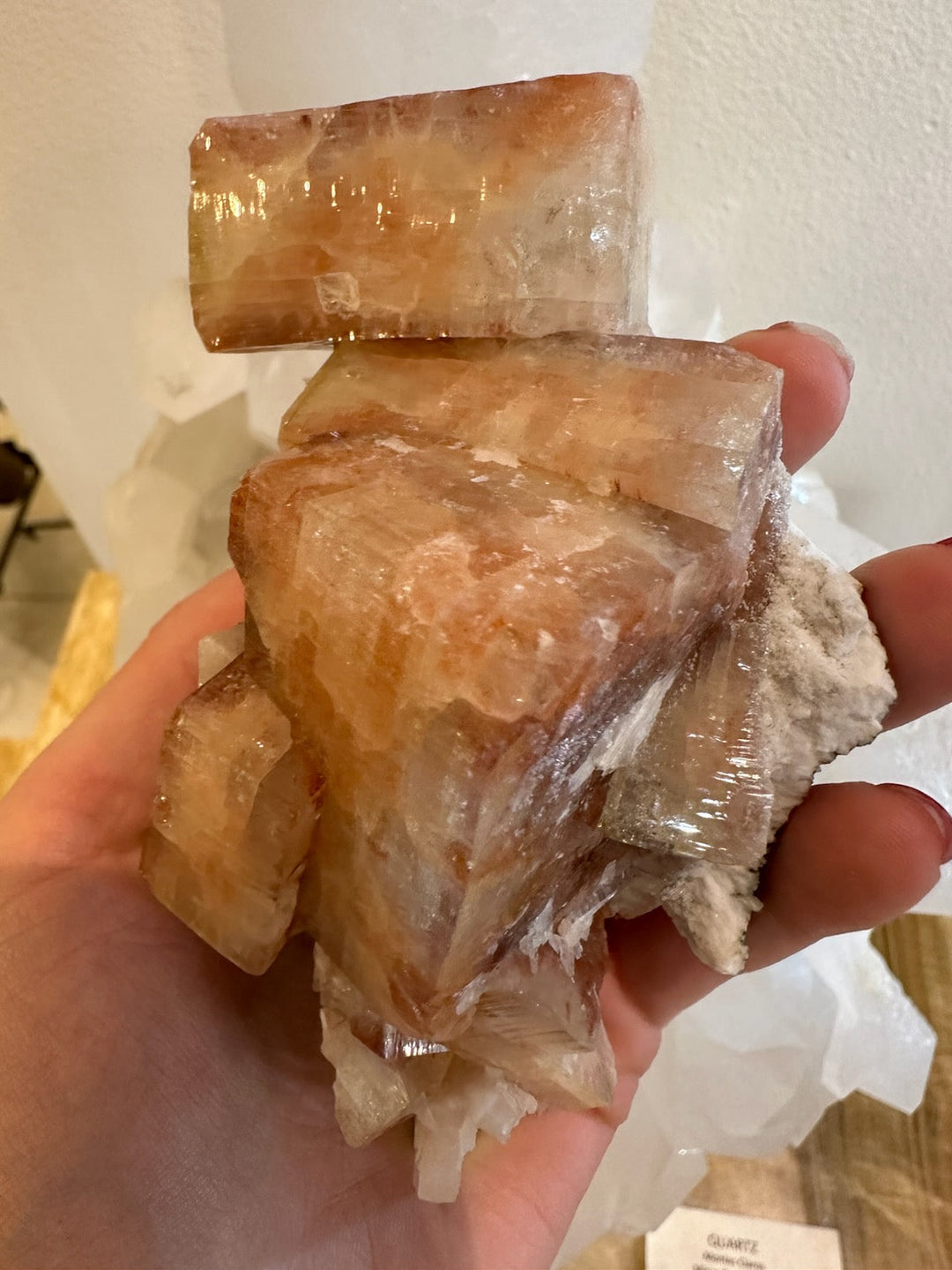 Orange-red apophyllite cubes with stilbite on white rock matrix, close-up