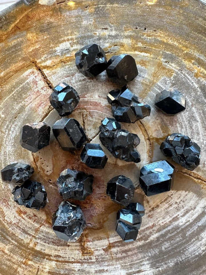Rough melanite garnet crystal cluster, dark black with blue reflective facets
