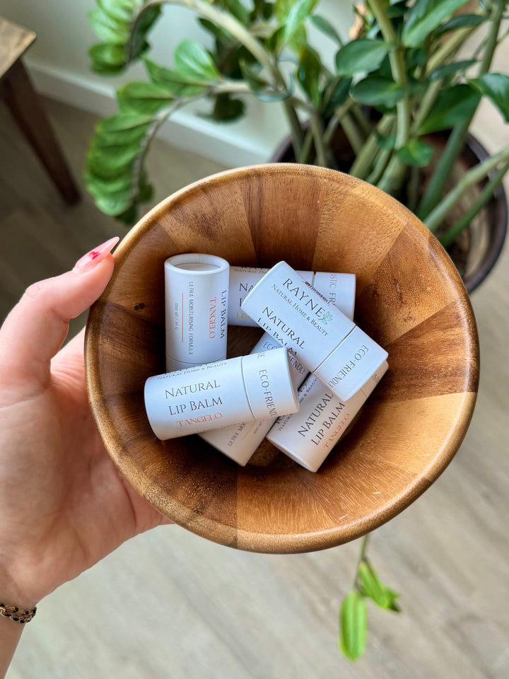 Natural lip balm set in a wooden bowl, white tubes with Natural Lip Balm labels