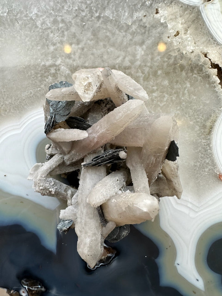 Dogtooth calcite cluster with mica, pale prismatic crystals and dark mica flakes