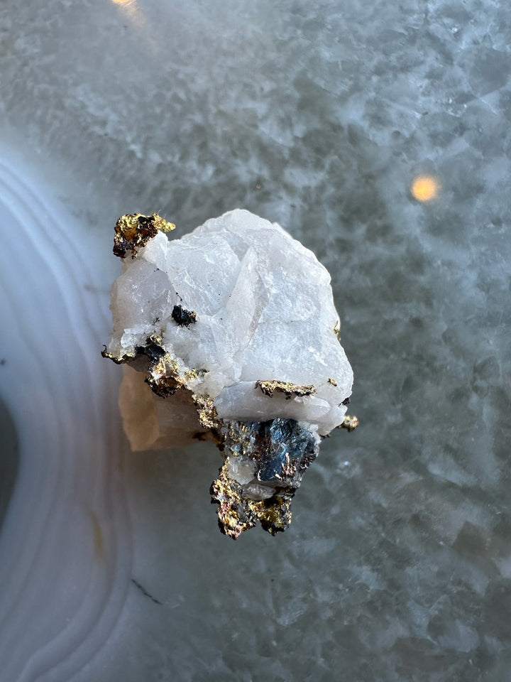 Quartz crystal with golden pyrite and dark metallic matrix mineral specimen