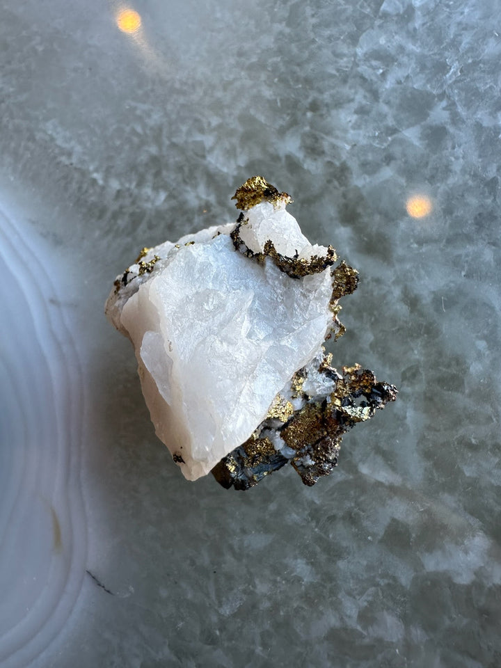 White quartz crystal cluster with golden pyrite mineral specimen, angled view