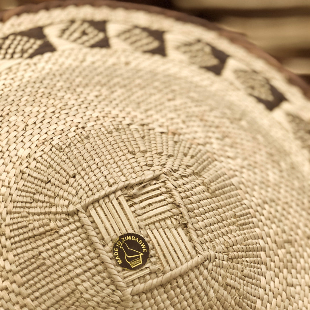 Woven basket base with circular brand stamp label at the center