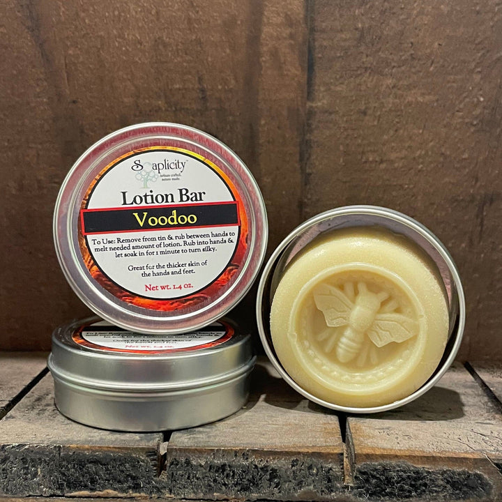 Lotion bar in round metal tin, lid open to reveal pale yellow balm