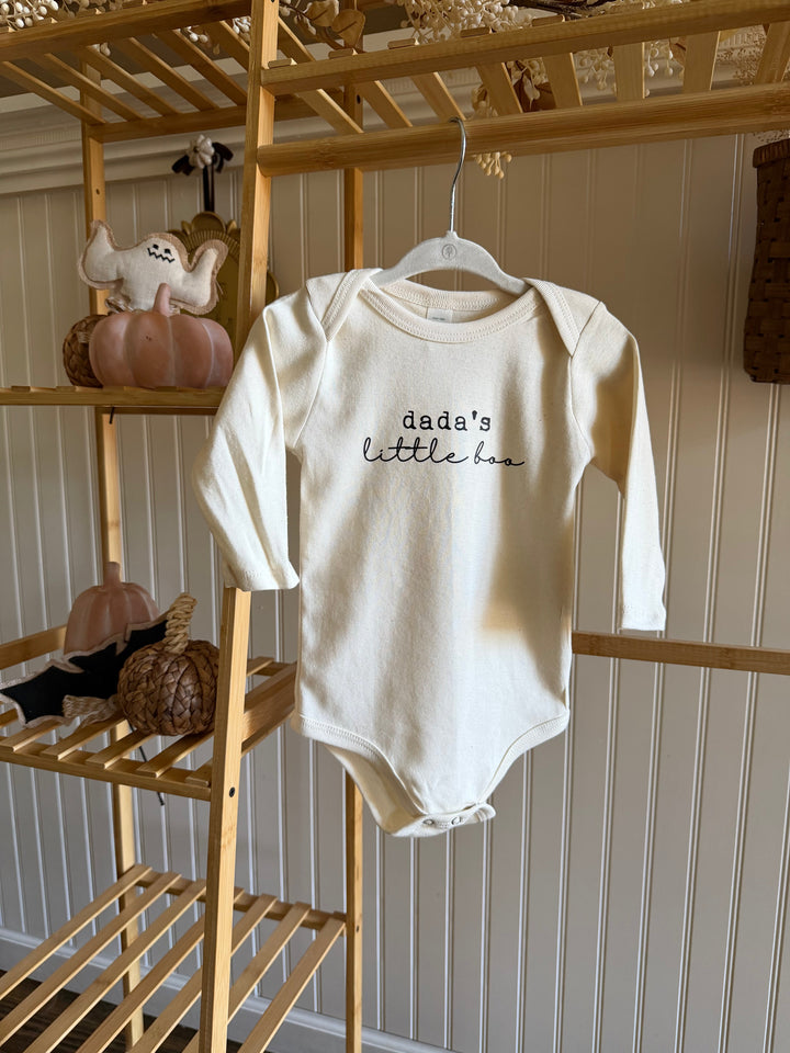 Cream long-sleeve baby bodysuit on hanger with &