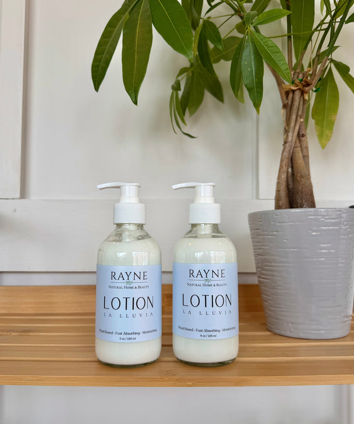 Moisturizing body lotion bottles with pump, light blue labels, RAYNE brand.