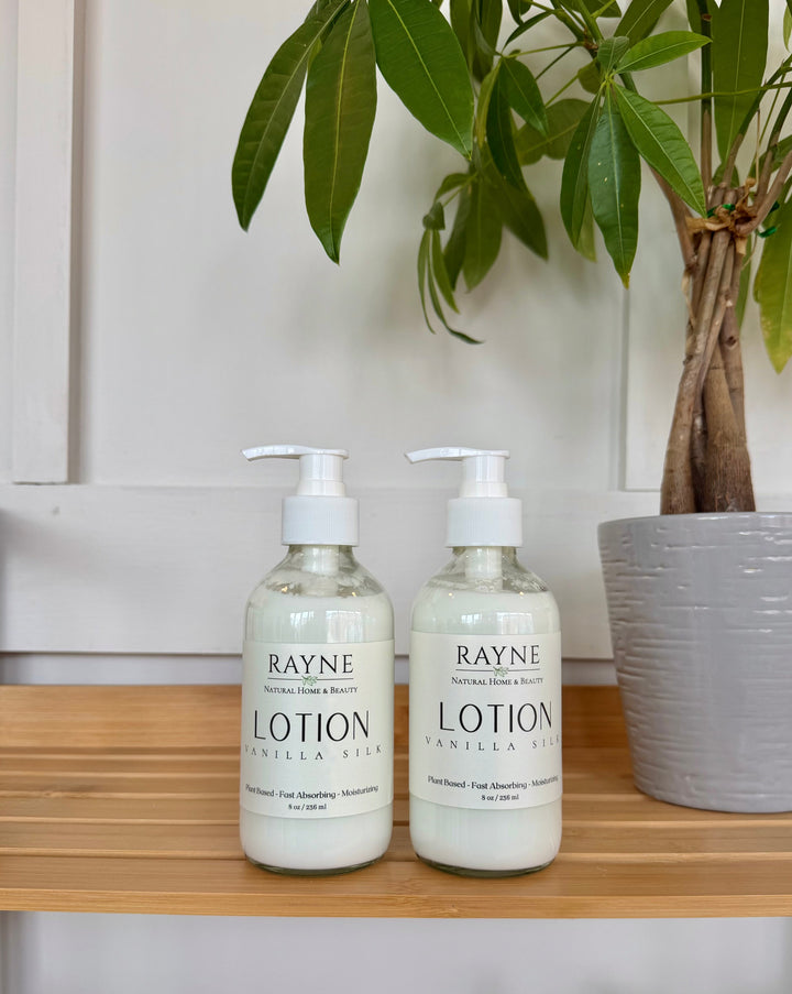 Cream body lotion bottles with white pumps, Rayne label on countertop