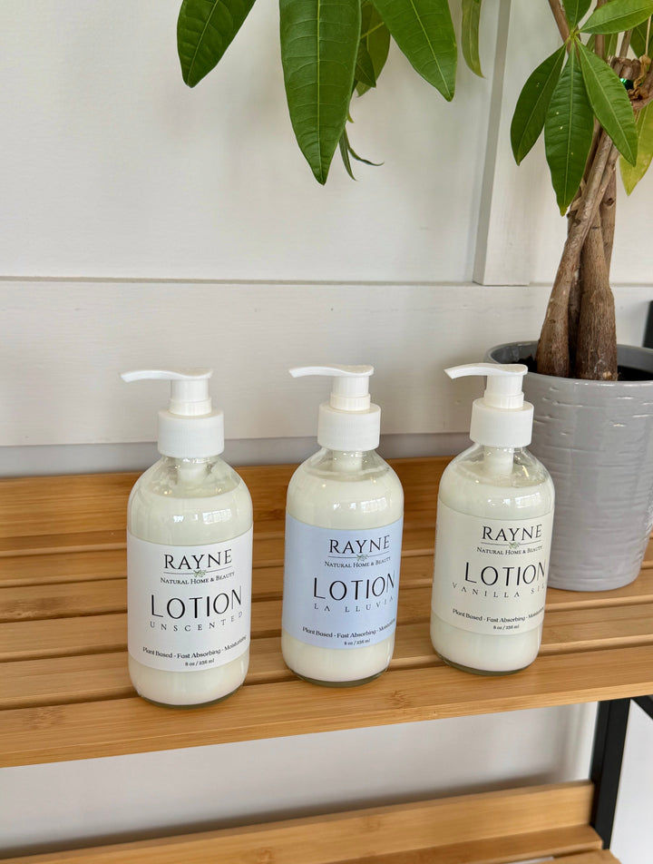 Moisturizing body lotion bottles with pumps, light blue labels, RAYNE brand, three-pack.