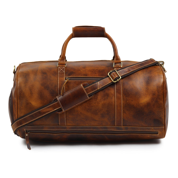 Brown leather duffel bag with top handles, crossbody strap, and zipper closure.