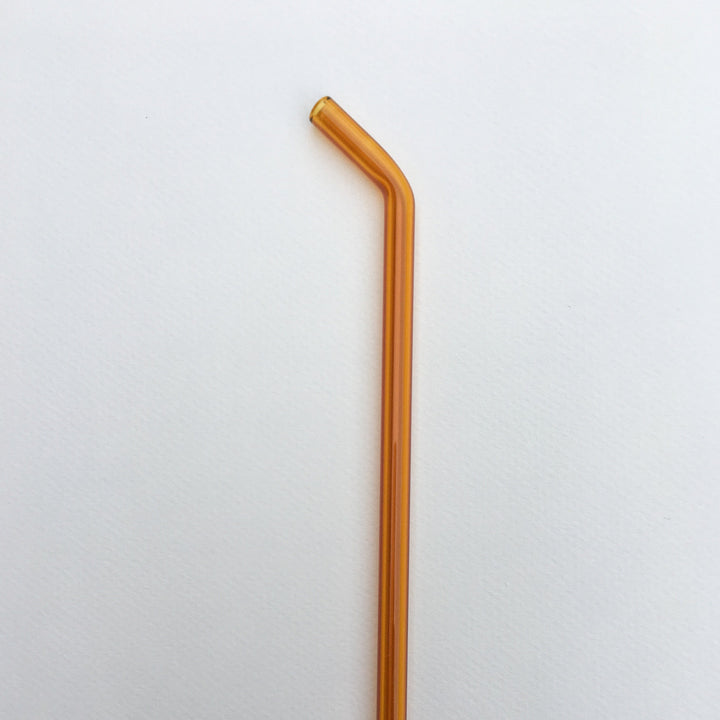 10-inch bent straw in amber orange, single straw on white background