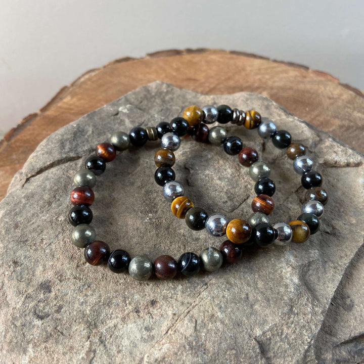 Bead bracelet with dark black and multicolor tiger eye stones and silver-tone accents.
