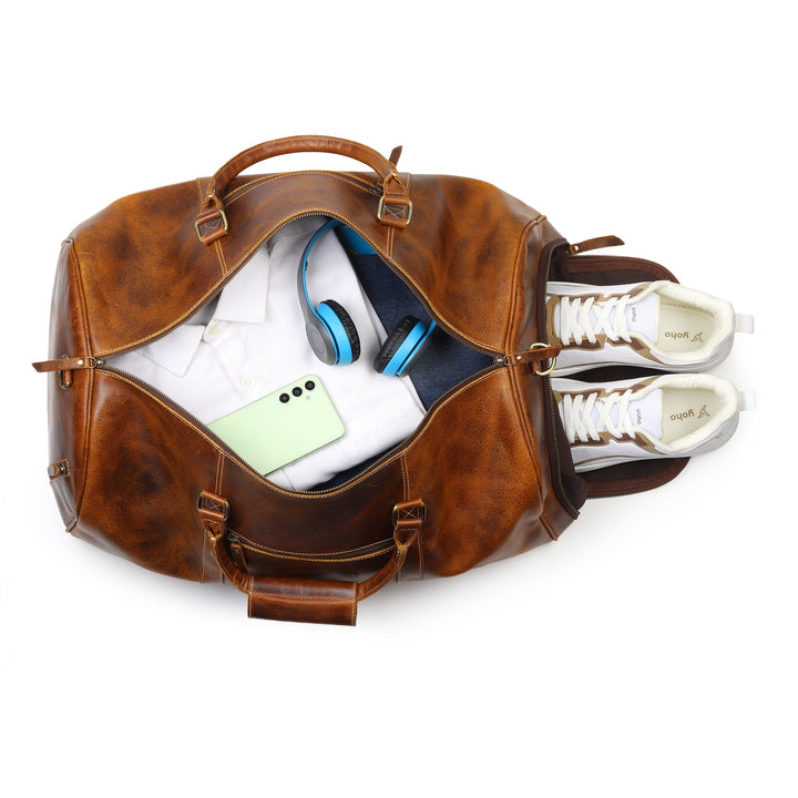 Brown leather duffel bag open with interior gear compartments and side straps.