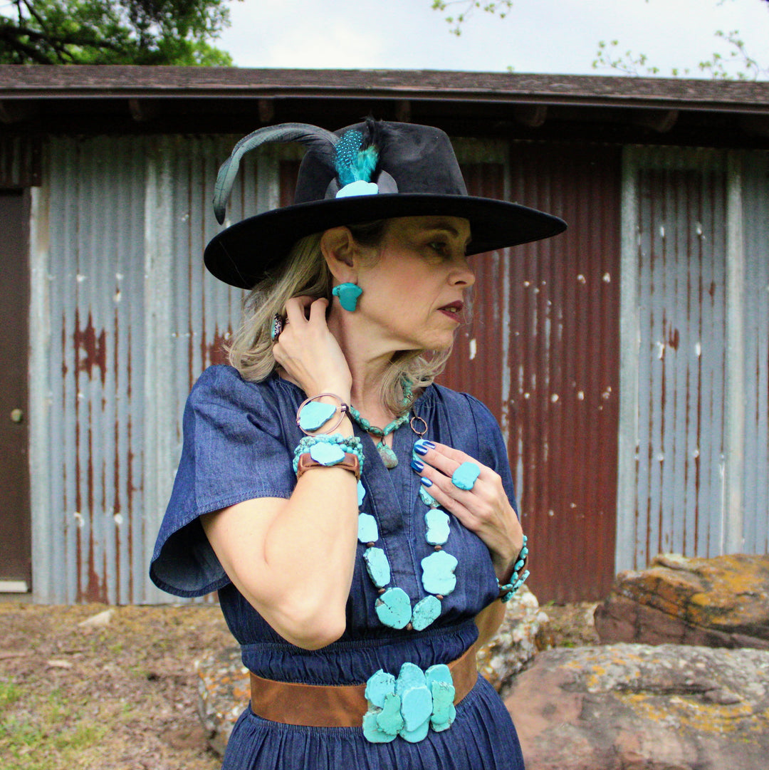 Turquoise slab earring studs on model, side view; irregular blue shapes