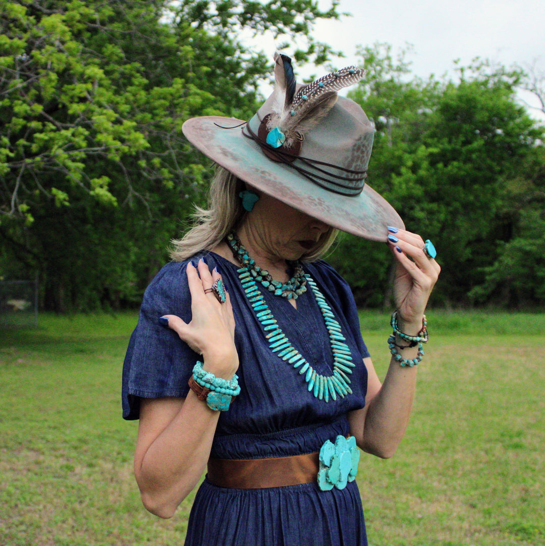 Beaded leather double-wrap bracelet with turquoise and white beads on wrist