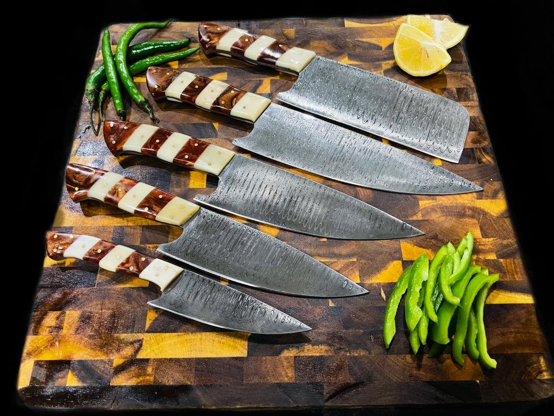 Five Damascus-style kitchen knives with wood-and-cream handles