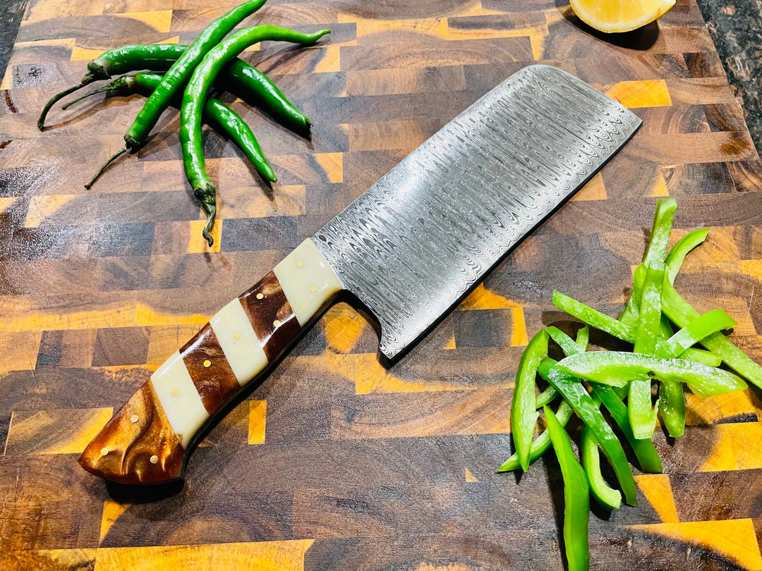 Damascus-style chef knife with ridged steel pattern and wood-and-cream handle
