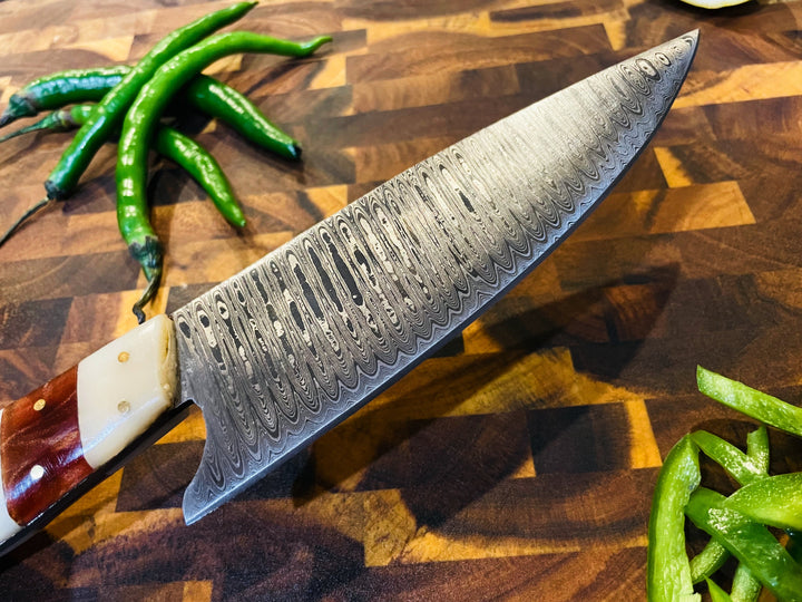 Damascus-style chef knife angled view with wavy blade pattern and wood handle