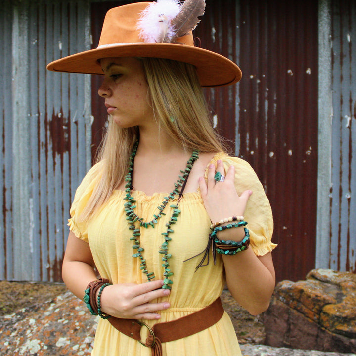 Beaded wrap bracelets with turquoise, white, and dark brown beads on wrist
