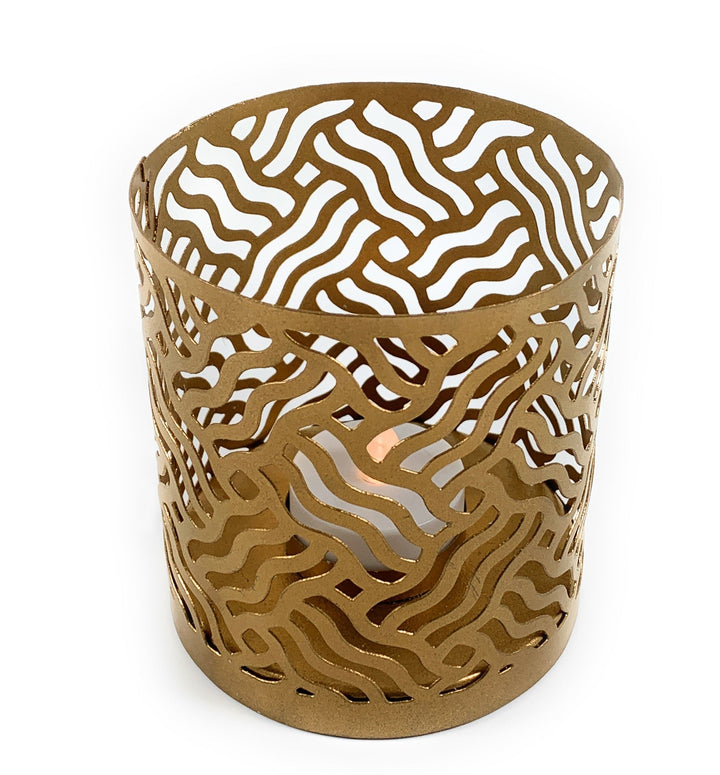 Gold-toned perforated votive candle holder with wavy abstract cutout pattern