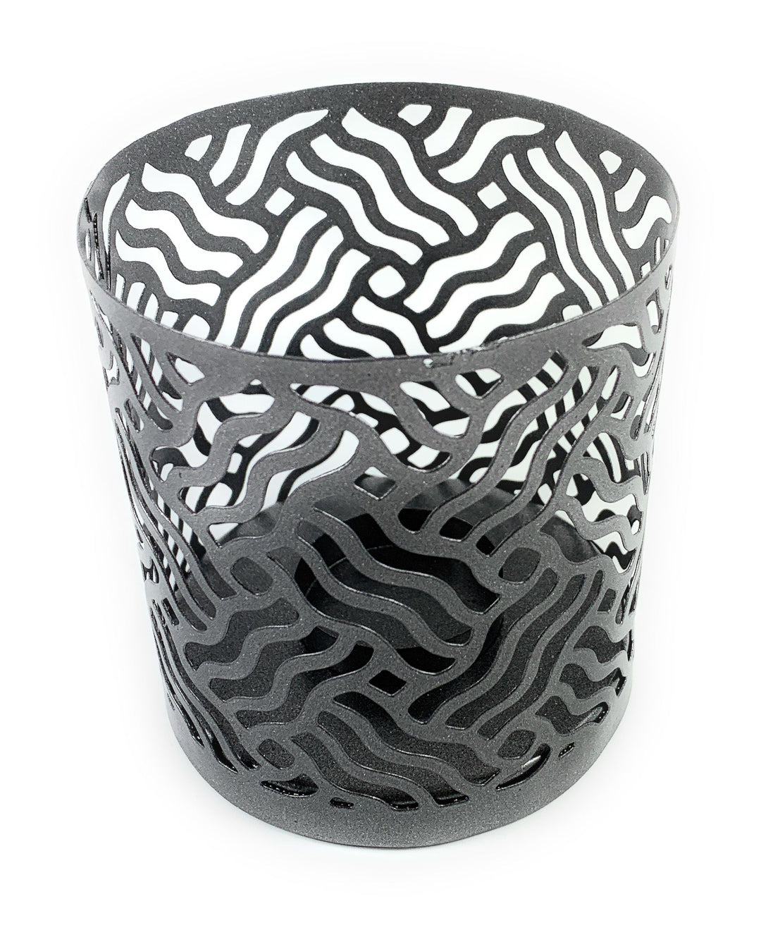 Grey perforated metal votive candle holder with curved cutout swirls, cylindrical