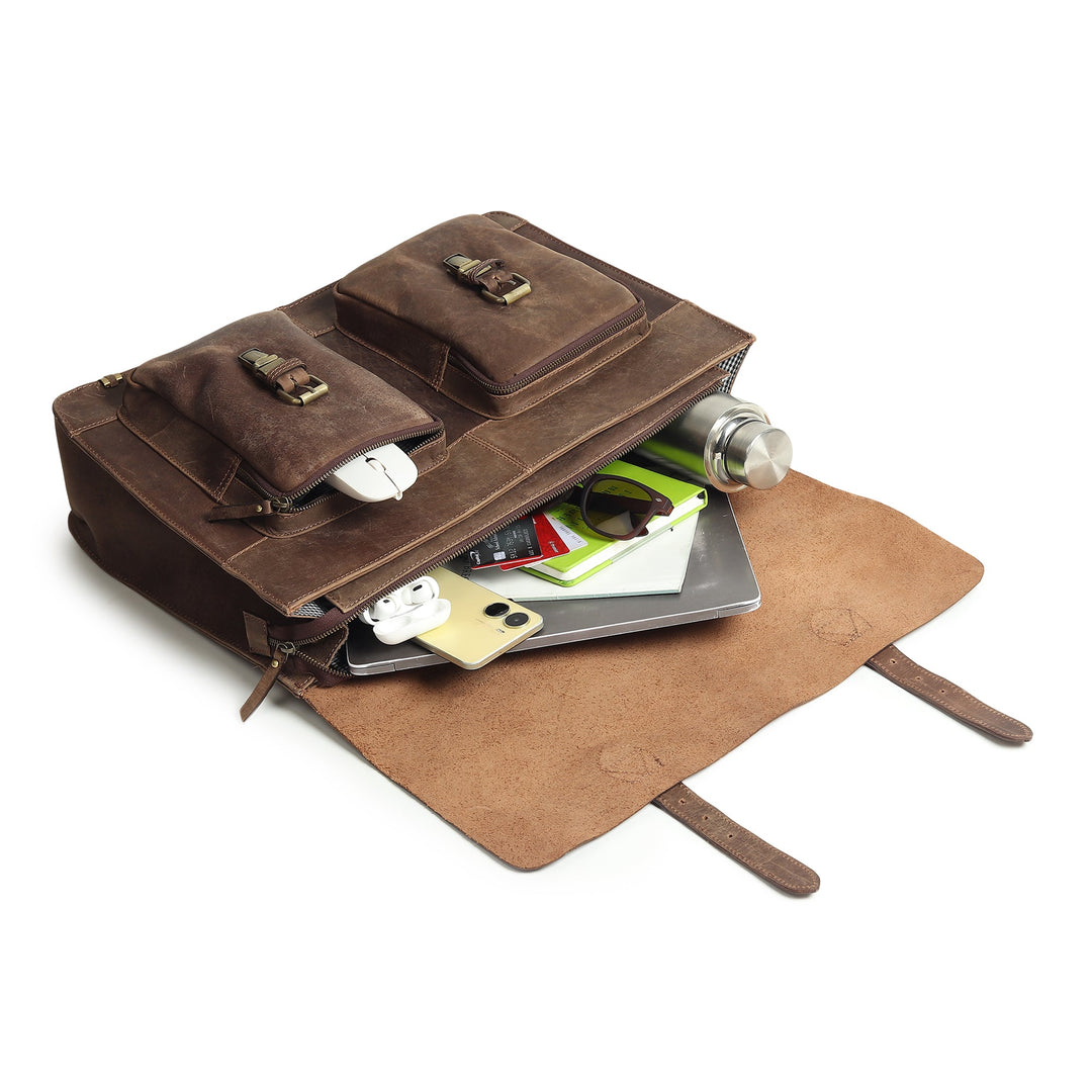 Open brown leather messenger bag with front compartments and documents inside