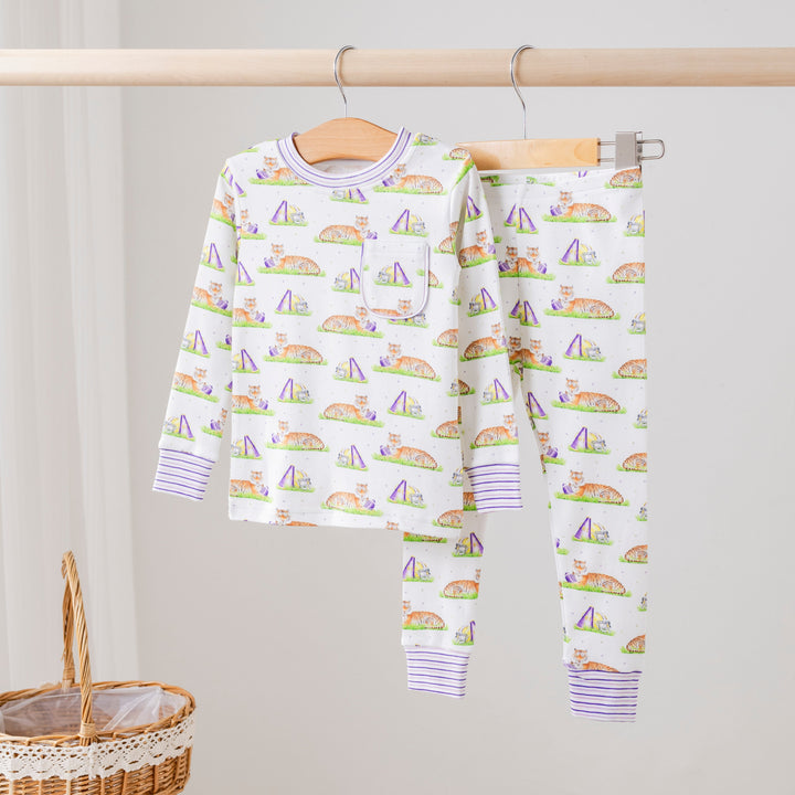 Kids long-sleeve pajama set in white with multicolor icon print and purple cuffs