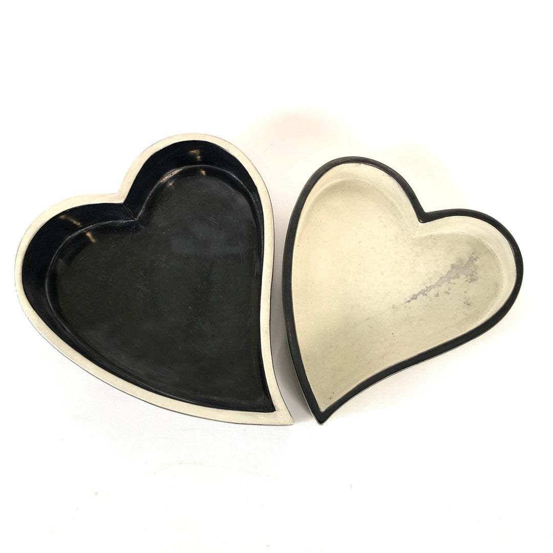 Pair of heart-shaped bowls, black and white, nested with contrasting outer trim