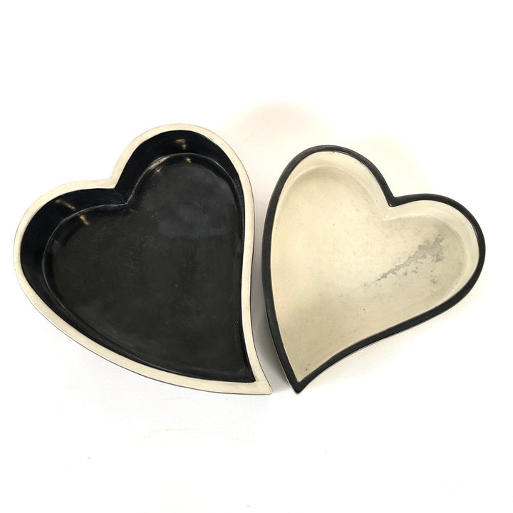 Pair of heart-shaped bowls, black and white, nested with contrasting outer trim