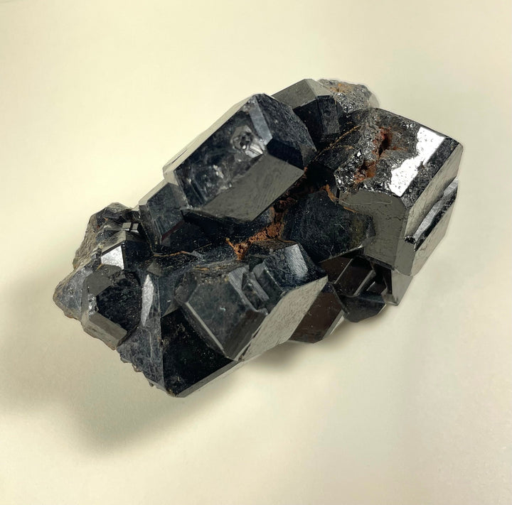 Melanite garnet cluster mineral specimen with dark metallic crystal facets