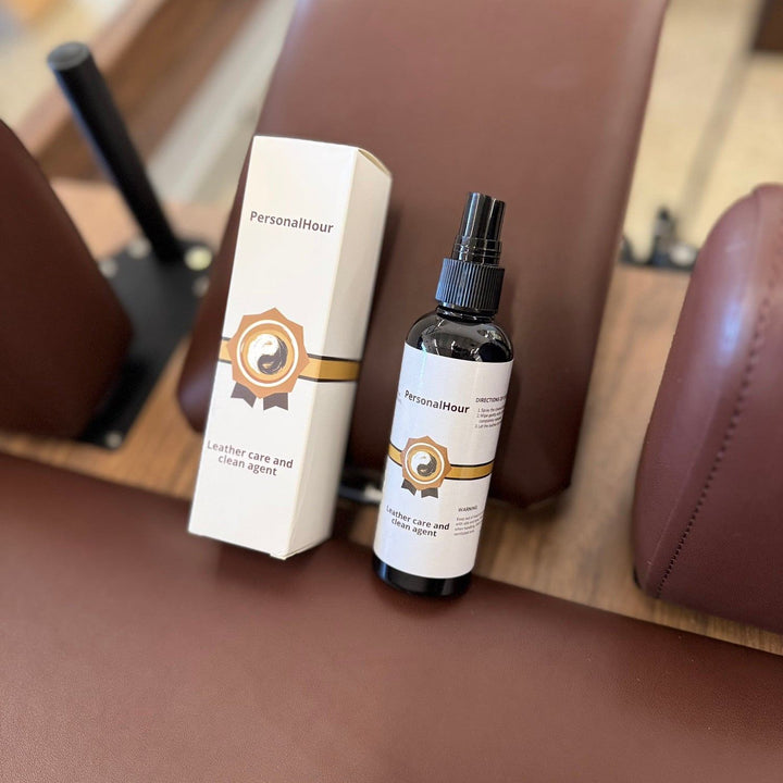 Leather care spray bottle with white carton and brown-gold logo