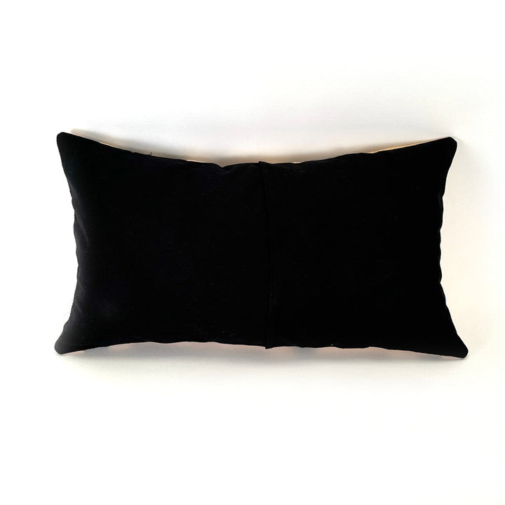 Rectangular pillow cover in solid black fabric with a sewn center seam