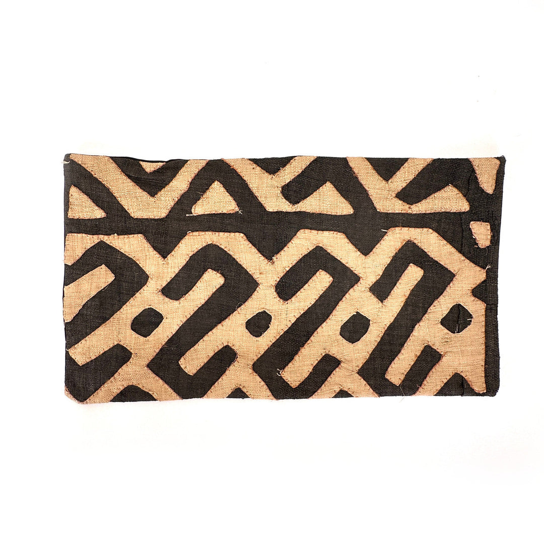 Rectangular Kuba cloth pillow cover with black and tan zigzag motif and stitched edge