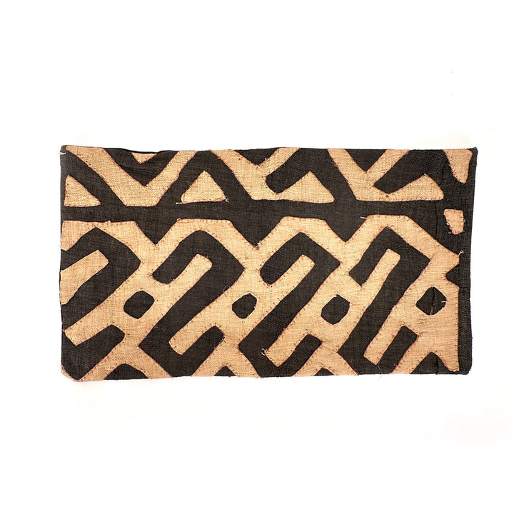 Rectangular Kuba cloth pillow cover with black and tan zigzag motif and stitched edge