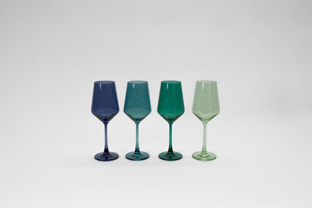 Set of 4 stemmed colored wine glasses: dark blue, teal, green, light green.