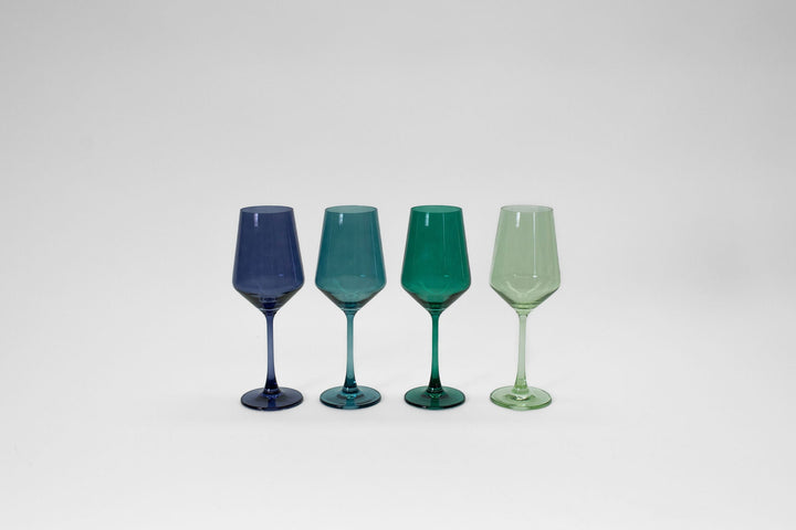 Set of 4 stemmed colored wine glasses: dark blue, teal, green, light green.