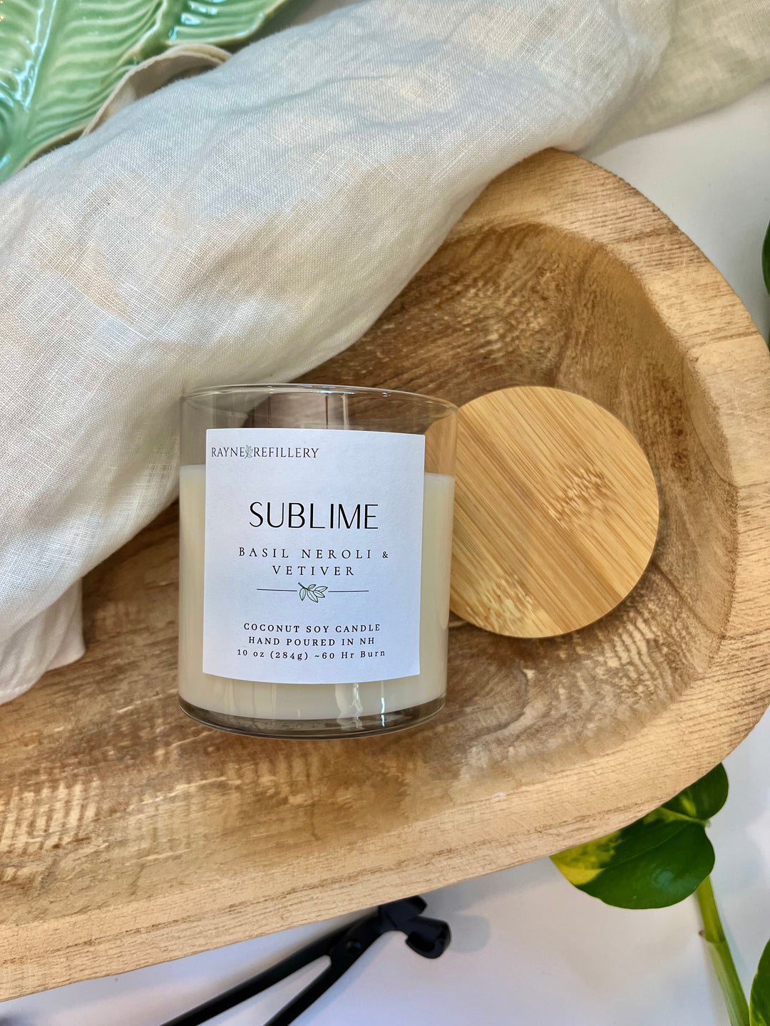 Coconut soy candle in clear glass jar with white wax and wood lid