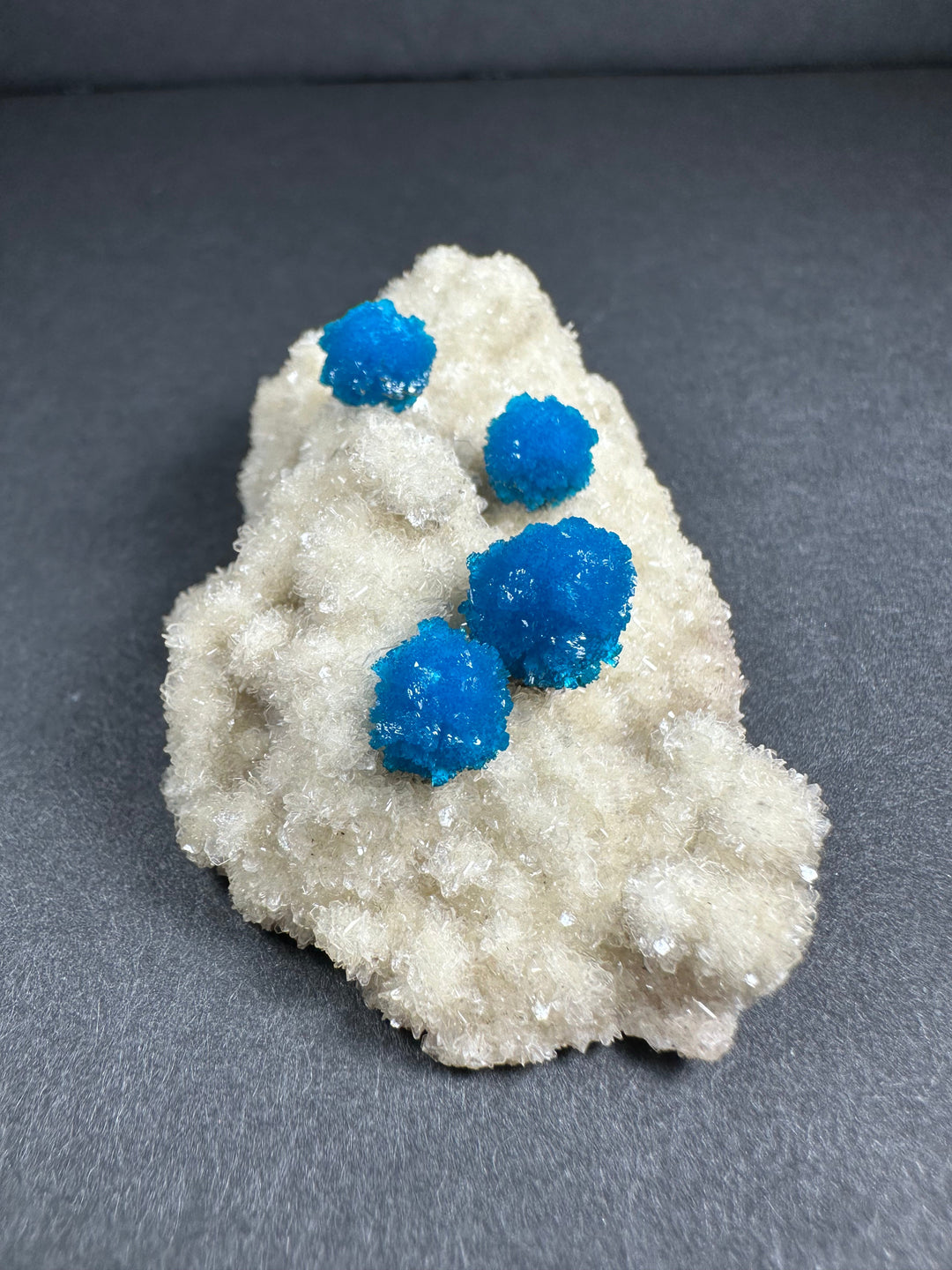 Blue cavansite crystals on white stilbite matrix, mineral specimen