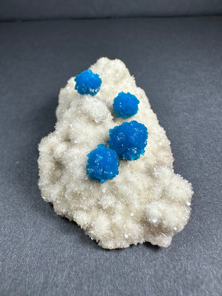 Blue cavansite crystals on white stilbite matrix, mineral specimen