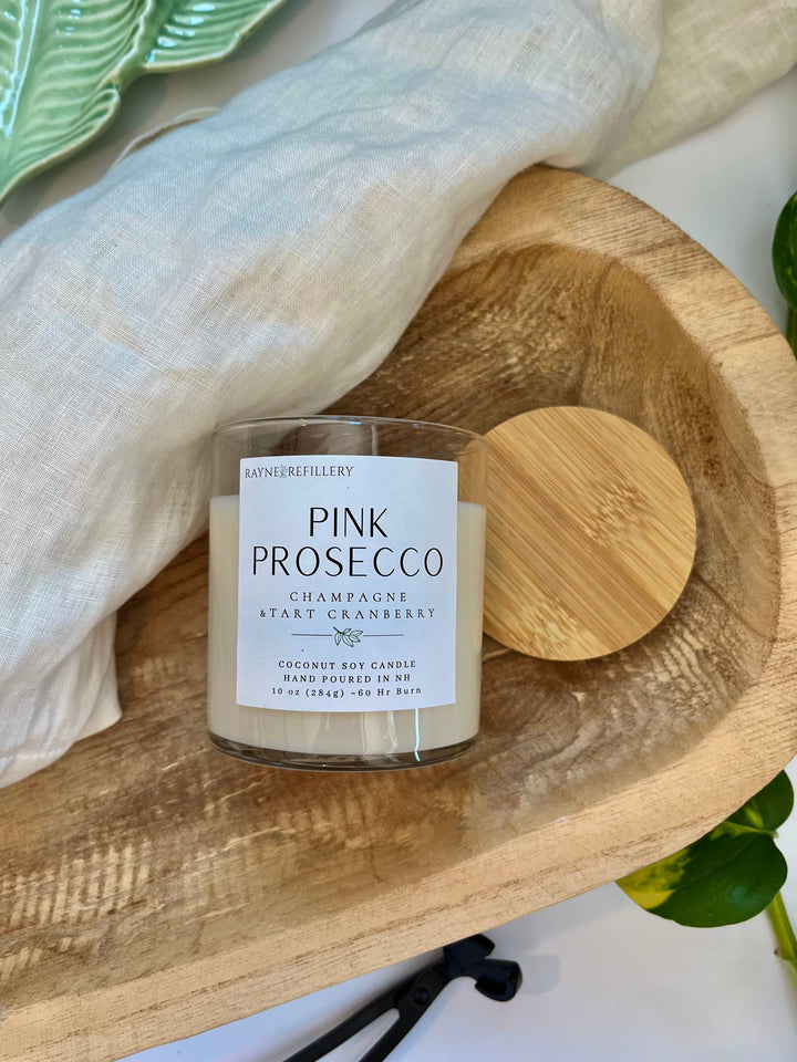 Pink Prosecco coconut soy candle in clear glass jar on wooden tray
