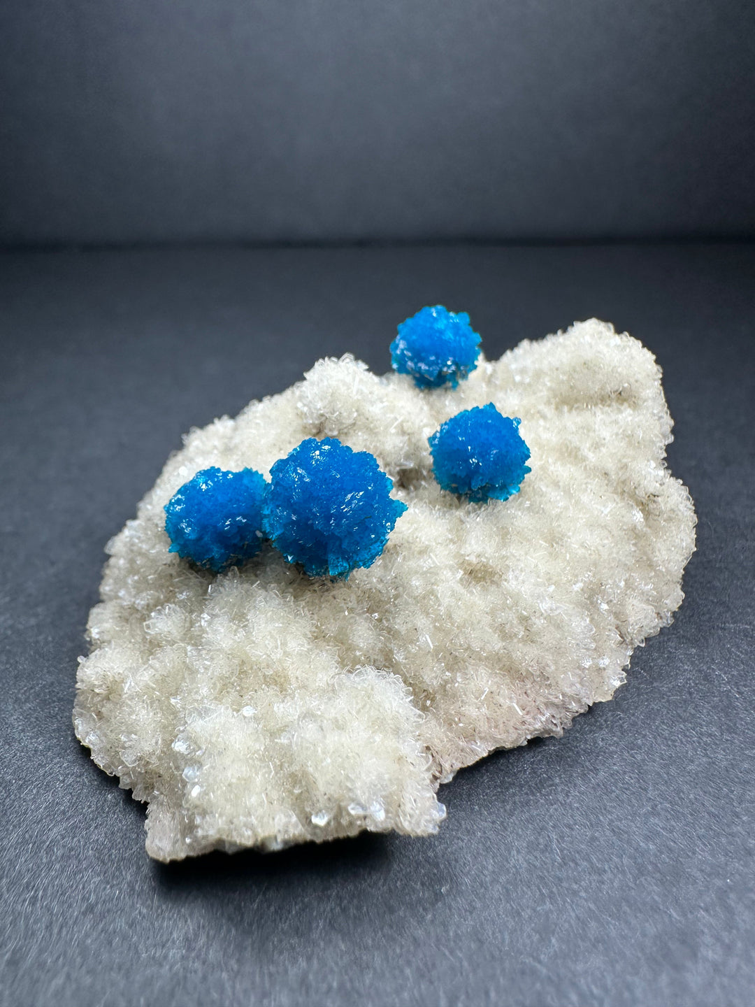 Blue cavansite clusters on white matrix, textured mineral specimen