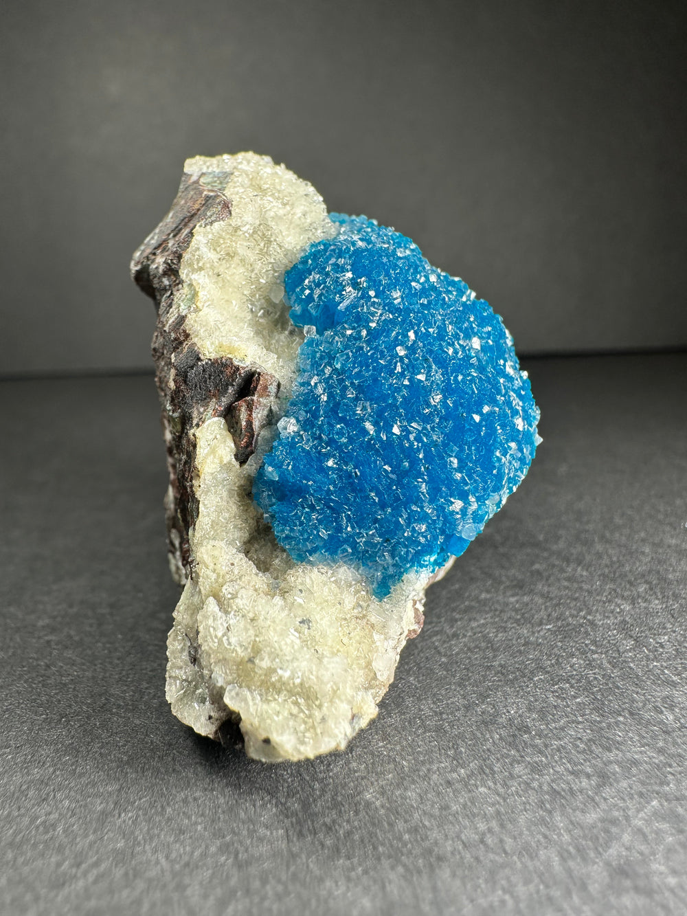Blue cavansite cluster on white and gray stilbite matrix, side view mineral specimen