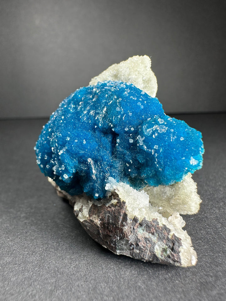 Blue cavansite crystal cluster on pale stilbite matrix with dark rock base